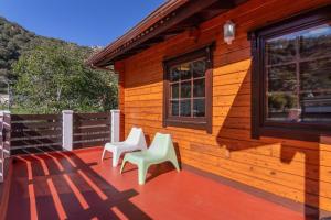 two white chairs sitting on the porch of a house at Villa Tanqueta in Santa Brígida