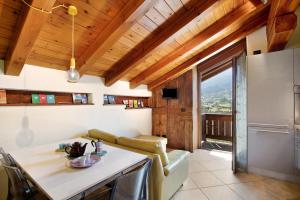 a kitchen and living room with a large window at Pelòt-de la Masse in Aosta