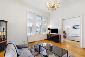 a living room with a couch and a table at Villa am Weinberg in Wiesbaden