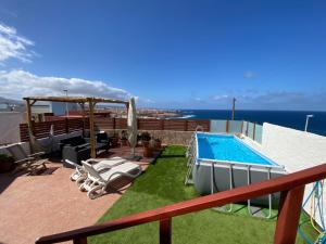 a balcony with a swimming pool on top of a building at Olas De Plata in Playa del Hombre