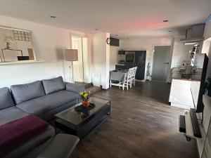 a living room with a couch and a table at Bergisch Resort Josef in Lindlar