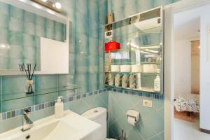 a blue tiled bathroom with a sink and a toilet at Olas De Plata in Playa del Hombre +29 photos