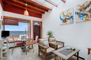 a living room with a view of the ocean at Olas De Plata in Playa del Hombre