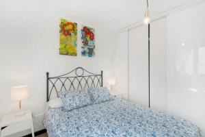 a bedroom with a bed with a blue comforter at Olas De Plata in Playa del Hombre