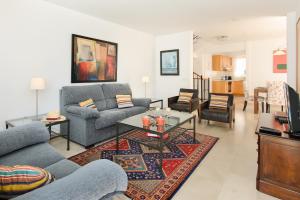 a living room with two couches and a table at Luis ii in Puerto del Carmen