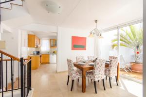a kitchen and dining room with a table and chairs at Luis ii in Puerto del Carmen