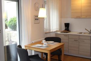 a small kitchen with a table and chairs and a table and a table and chairs at Lautertal Zinne in Hayingen +7 photos
