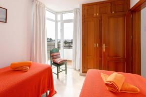 a bedroom with two beds and a door with a window at Luis ii in Puerto del Carmen +17 photos
