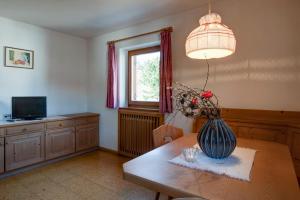 a dining room with a table with a vase on it at Apartment 5 - Zur Sonne in Laion