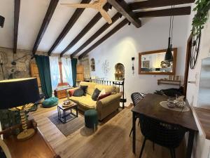 a living room with a couch and a table at Casa Trinidad in Denia