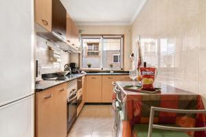 a kitchen with a table with a wine glass on it at Costamar Arinaga in Arinaga +17 photos