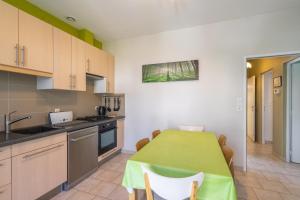 a kitchen with a table with a green table cloth at Maison Individuelle, Royan Centre in Royan