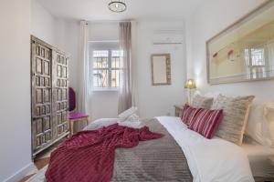 a bedroom with a large bed in a room at Barsanz Palace Home in Alcalá del Valle