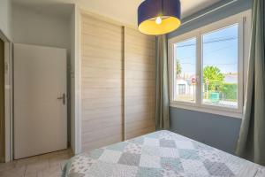 a bedroom with a bed and a window at Maison Individuelle, Royan Centre in Royan