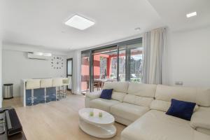 a living room with a white couch and a table at Alexandria's Retreat in San Bartolomé