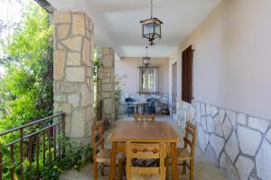a dining room with a table and chairs on a balcony at Espacio Rural La Cabaña de Miraflores in Miraflores de la Sierra