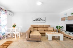 a living room with a couch and a table at Casa Pepe junto al mar in Benajarafe