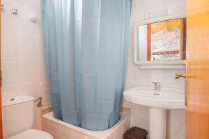 a bathroom with a sink and a toilet and a shower at Casa Batlle Boix in Les Iglésies