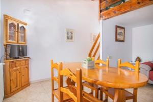 a dining room with a wooden table and chairs at Casa Batlle Boix in Les Iglésies +5 photos