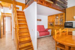 a staircase in a kitchen and a dining room with a table at Casa Batlle Boix in Les Iglésies