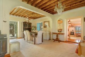 a dining room with a table and a chandelier at Lefkadas Bohemian Cottage in Lefkada
