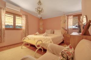 a bedroom with a bed and a couch at Lefkadas Bohemian Cottage in Lefkada