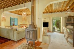a living room with a fireplace and a couch at Lefkadas Bohemian Cottage in Lefkada