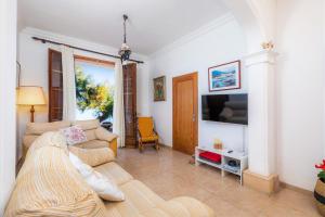 a living room with a couch and a tv at Sa Marina in Alcudia