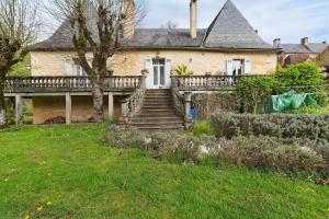 an external view of a house with a porch and stairs at La Belle Gabarre in Groléjac
