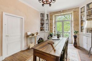 a home office with a wooden table and a window at La Belle Gabarre in Groléjac