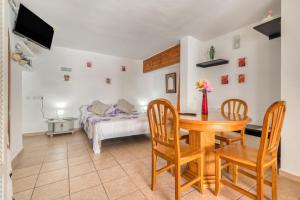 a room with a table and chairs and a bed at La Finca Moraira in Teulada