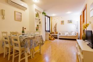 a kitchen and living room with a table and chairs at Sauc Beach Apartment in Canet de Mar