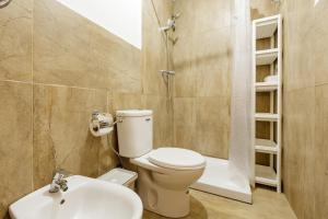 a bathroom with a toilet and a sink and a shower at Sauc Beach Apartment in Canet de Mar
