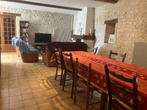 a living room with a table and a couch at Chez Bilhouet in Segonzac