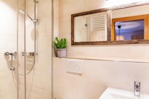 a bathroom with a shower and a sink at Ferienwohnung Zugspitzblick in Farchant +13 photos