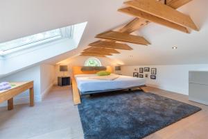 a attic bedroom with a bed and a rug at Appartement Halbinsel Wittow in Binz