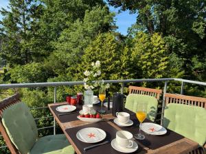 a wooden table with glasses of wine on a balcony at Appartement Halbinsel Wittow in Binz