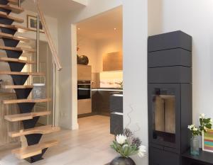 a living room with a spiral staircase and a kitchen at Appartement Halbinsel Wittow in Binz +10 photos