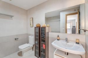 a bathroom with a sink and a toilet and a mirror at Casa Graham 14 in Tazacorte +16 photos