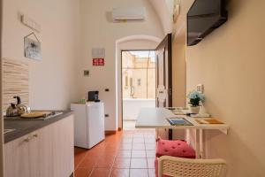 a kitchen with a counter and a table in a room at Sg Apartment Standard in Massafra