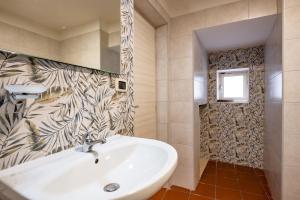 a bathroom with a white sink and a window at Sg Apartment Standard in Massafra +12 photos
