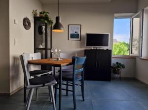 a dining room with a wooden table and chairs at moselquartier terlinden- Apartment in Besch