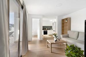 a living room with a couch and a table at Suite Deluxe Puerto Rico 11 in Puerto Rico de Gran Canaria