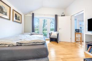 a bedroom with a bed and a large window at Alter Laden in Nienstädt