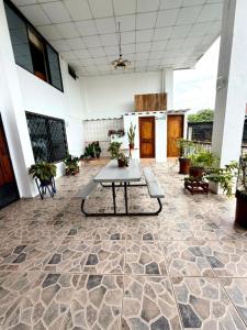 a patio with a table and potted plants in a building at Hotel Nivel 5 in Macas +7 photos