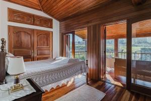 a bedroom with a large bed and a balcony at Quinta Das Regadas in Rendufe +26 photos