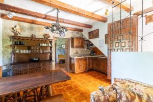 a kitchen with wooden cabinets and a wooden table at Isla Del Burguillo in Ávila