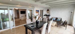 a living room with a dining room table with chairs at Beach House El Saladillo in Estepona