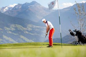 a man is playing golf on a golf course at Appartement Christoph in Ried im Zillertal