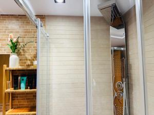 a shower with a glass door in a bathroom at Comodidad cerca del centro Granada in Albolote +33 photos